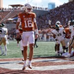 arch-manning-throws-first-college-touchdown,-runs-for-another-in-impressive-texas-showing