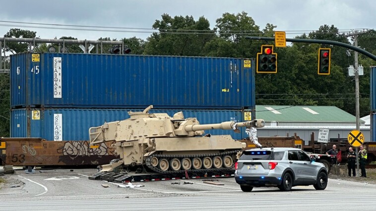 train-collides-with-military-mobile-artillery-vehicle-being-hauled-on-a-semi-truck