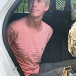 suspect-in-trump’s-would-be-assassin-ryan-routh-appears-calm-as-he-sits-handcuffed-in-back-of-police-car:-arrest-photo