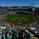 fans-throw-objects,-storm-field-during-final-a’s-game-in-oakland