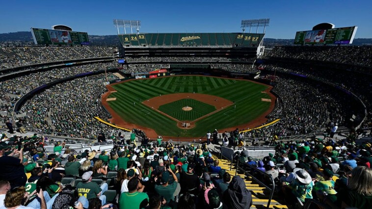 fans-throw-objects,-storm-field-during-final-a’s-game-in-oakland