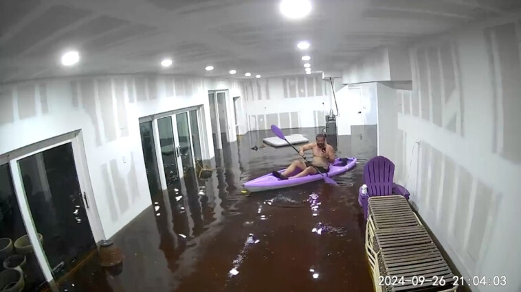 florida-man-paddles-around-tampa-home-as-helene-storm-surge-floods-living-room