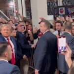 trump-greeted-by-chants-of-‘usa,’-tosses-popcorn-to-fans-as-he-attends-alabama-vs.-georgia-football-game