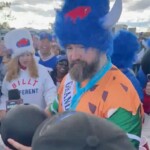 jason-kelce-takes-swig-from-bowling-ball-dressed-as-fred-flintstone-during-wild-bills-‘mnf’-tailgate