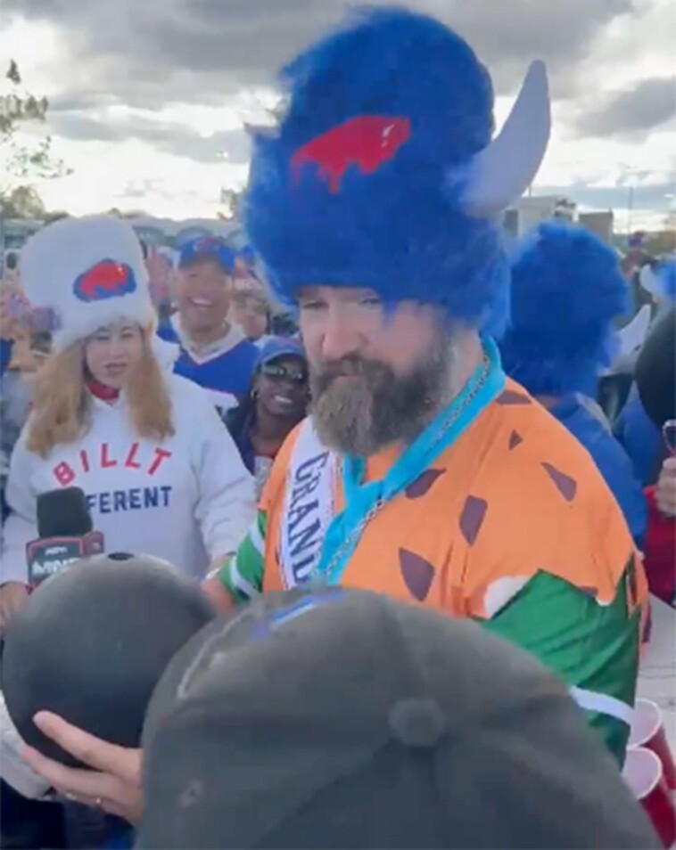 jason-kelce-takes-swig-from-bowling-ball-dressed-as-fred-flintstone-during-wild-bills-‘mnf’-tailgate