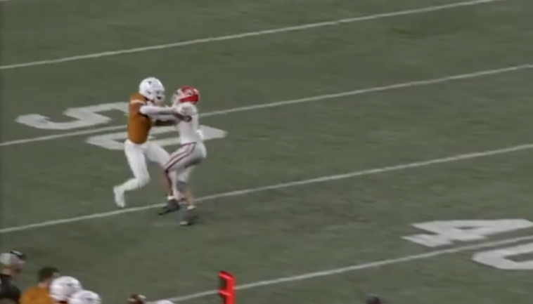 officials-reverse-controversial-texas-pass-interference-call-during-delay-for-fans-throwing-objects-onto-the-field