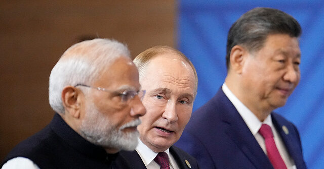 brics-summit,-day-2:-putin-scores-by-embracing-xi-and-modi