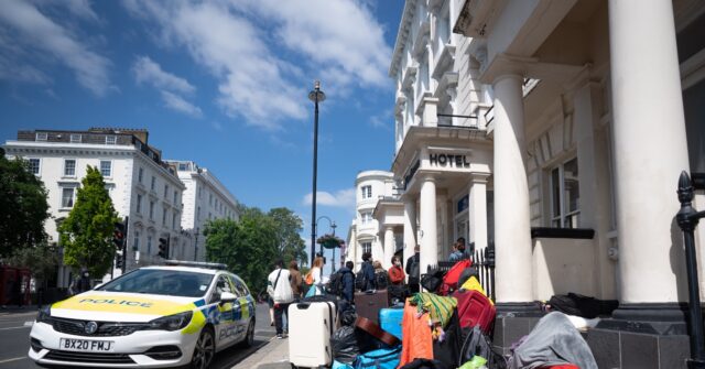 migrants-to-be-housed-in-uk-hotels-for-another-three-years-as-gov’t-struggles-to-clear-backlog:-report