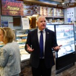 watch:-dejected-tim-walz-stares-at-pizza-as-reporters-confront-him-about-his-‘school-shooter’-comment