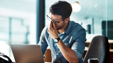 man-torn-between-working-from-home-and-being-interrupted-by-kids,-working-at-office-and-being-interrupted-by-coworkers