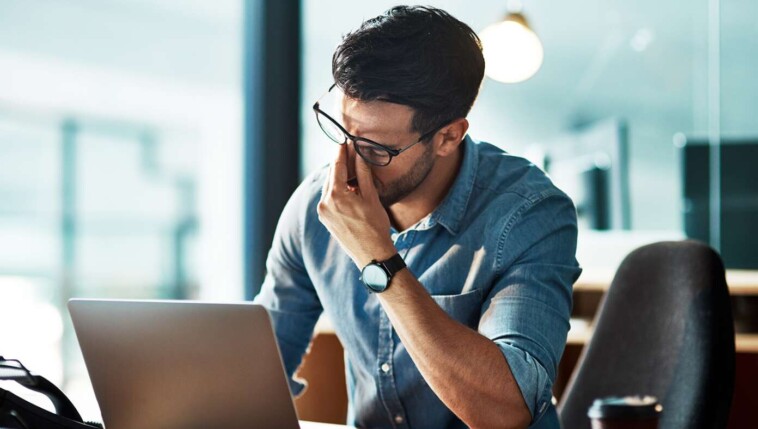 man-torn-between-working-from-home-and-being-interrupted-by-kids,-working-at-office-and-being-interrupted-by-coworkers