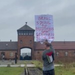 polish-artist-sparks-outrage-outside-auschwitz-with-sign-saying-‘israel-is-doing-to-the-palestinians-what-the-germans-did-to-the-jews’