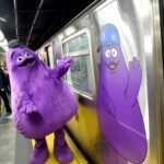 grimace-rides-the-rails-on-nyc’s-purple-line-with-mets-fans-ahead-of-nlds-game-3-against-phillies