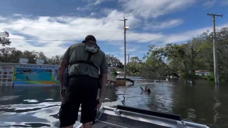 florida-deputies-rescue-boy-floating-on-piece-of-fence-in-floodwaters