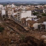 mud-caked-volunteers-clean-flood-debris-in-a-spanish-town-as-authorities-struggle-to-respond