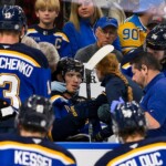 blues-player-hit-in-neck-with-puck,-keeps-playing-before-eventually-being-stretchered-off