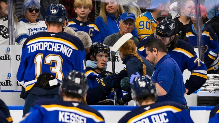 blues-player-hit-in-neck-with-puck,-keeps-playing-before-eventually-being-stretchered-off