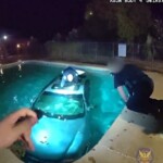 dramatic-rescue-of-driver-trapped-in-car-submerged-in-pool-captured-on-police-bodycam