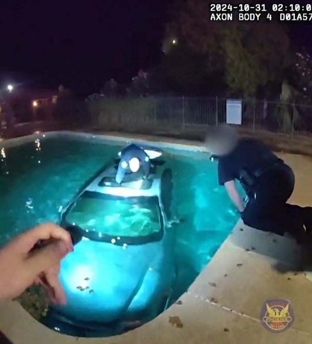 dramatic-rescue-of-driver-trapped-in-car-submerged-in-pool-captured-on-police-bodycam