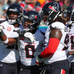 trevor-lawrence-injured-after-ugly-helmet-to-helmet-hit-by-azeez-al-shaair,-sparks-brawl-between-jaguars,-texans