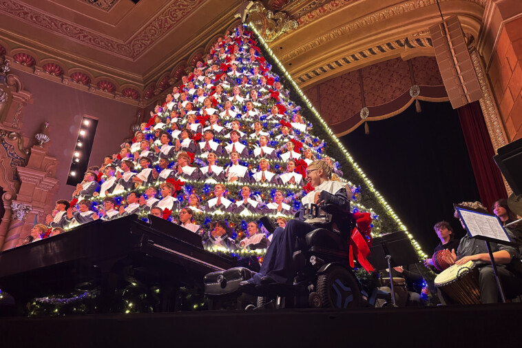 michigan-high-school-choir-performs-holiday-concert-from-67-foot-tall-christmas-tree-shaped-structure