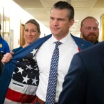 pete-hegseth-shows-reporters-a-patriotic-surprise-hidden-inside-his-suit-coat-as-he-meets-with-senators