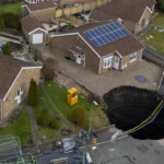 massive-sinkhole-swallows-road,-forces-families-to-evacuate-weeks-before-christmas