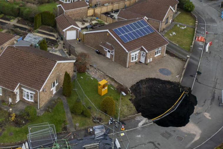 massive-sinkhole-swallows-road,-forces-families-to-evacuate-weeks-before-christmas