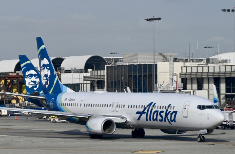 ‘anxious’-alaska-airlines-flyer-opens-emergency-exit-and-climbs-onto-plane-wing-during-deboarding