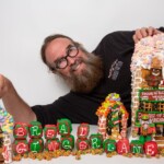 inside-nyc-gingerbread-man’s-massive-big-apple-themed-candy-city-with-hot-dog-stands,-cab-driving-santa-claus