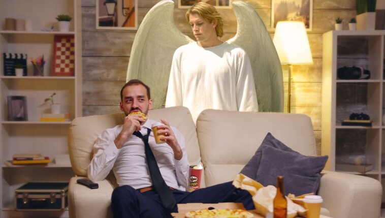 guardian-angel-dutifully-stands-over-man-watching-tv-to-make-sure-he-doesn’t-choke-on-his-pringles