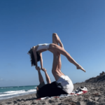 bill-belichick-helps-jordan-hudson-perform-wild-acrobatic-pose-on-beach