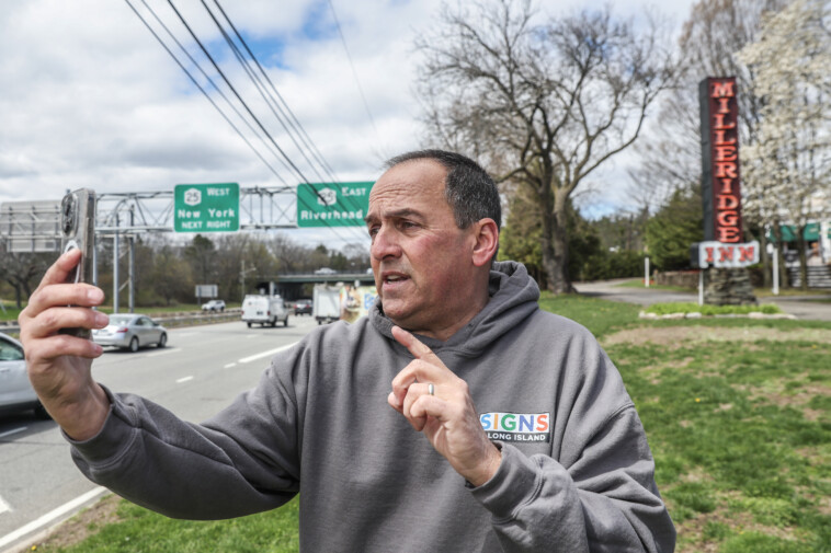 ‘long-island-sign-guy’-becomes-online-sensation-as-he-drives-‘all-over’-showing-viewers-‘huge-stories’