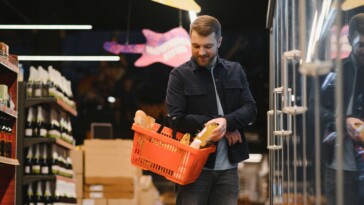 man-carries-grocery-basket-like-dainty-village-girl-skipping-through-orchard-picking-apples