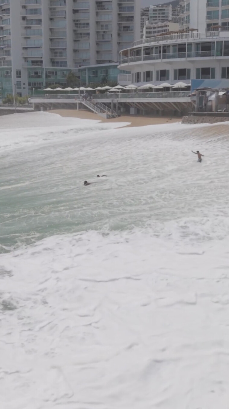 drone-video-captures-moment-giant-wave-swallows-up-swimmers-on-mexican-beach