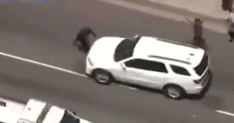 watch:-anti-ice-protester-in-la-partially-run-over-while-blocking-moving-ice-vehicle