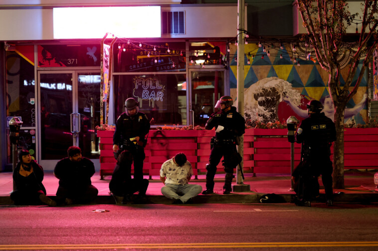 la-anti-ice-rioters-seen-being-zip-tied,-herded-away-in-buses-as-police-attempt-to-squash-mayhem
