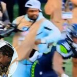 marshawn-lynch-stiff-arms-player-to-protect-his-camera-during-seahawks-preseason-game-in-wild-scene