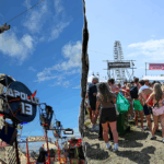 thrill-ride-malfunctions-at-popular-music-festival,-leaving-riders-stuck-upside-down