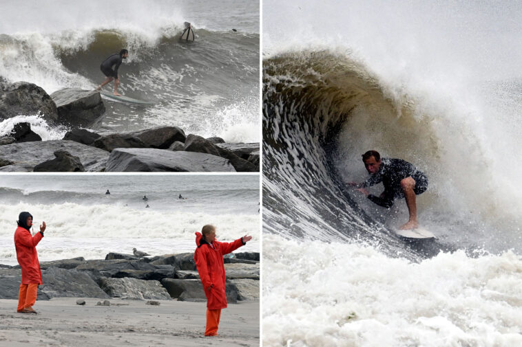 cowabunga!-surfers-riding-huge-waves-on-rockaway-beach-from-hurricane-erin —-as-storm-threatens-to-flood-coastal-areas