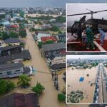 families-in-southern-thailand-perch-on-rooftops-to-escape-flooding-that-killed-at-least-33