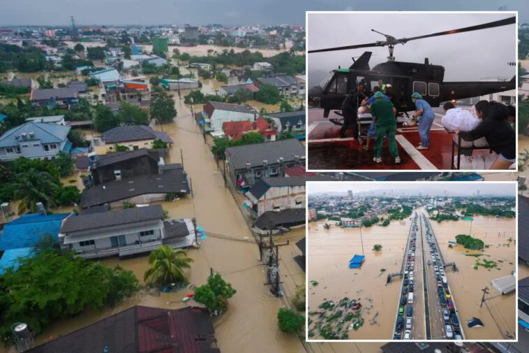 families-in-southern-thailand-perch-on-rooftops-to-escape-flooding-that-killed-at-least-33