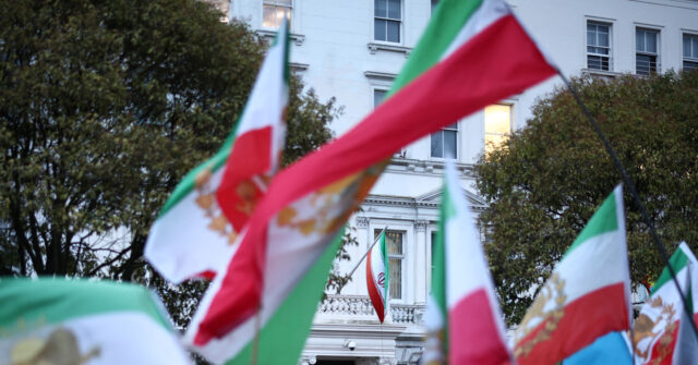 protester-hoists-pre-islamic-revolution-iran-flag-above-london-embassy
