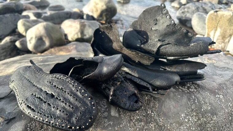 hundreds-of-mysterious-old-shoes-wash-up-on-beach-during-cleanup,-baffling-officials