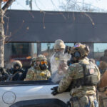 community-members’-with-rifles-stand-guard-in-minneapolis-where-armed-man-was-shot