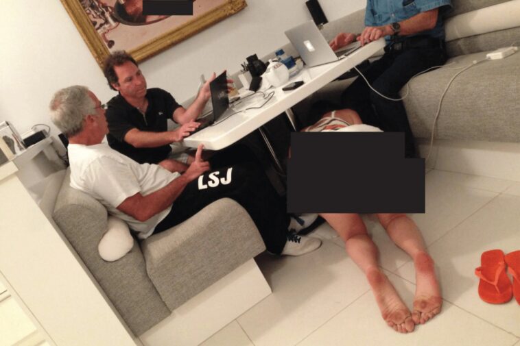 disturbing-photo-shows-epstein,-pals-sitting-unfazed-as-bikini-woman-crawls-under-table-by-naked-baby-picture