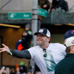 watch:-seahawks’-john-schneider-hands-out-tiny-jesus-figures-at-seattle-super-bowl-parade