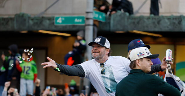 watch:-seahawks’-john-schneider-hands-out-tiny-jesus-figures-at-seattle-super-bowl-parade