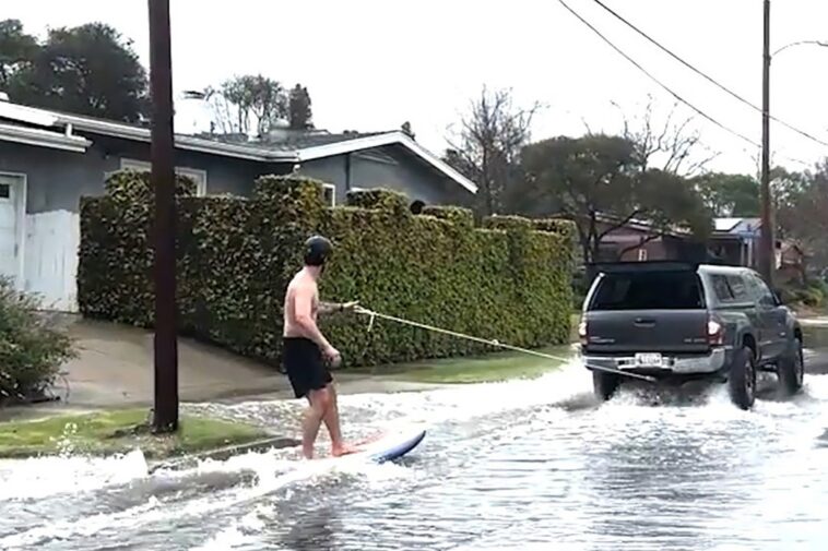 surfer-shreds-waves-on-socal-street-during-wild-flooding:-video