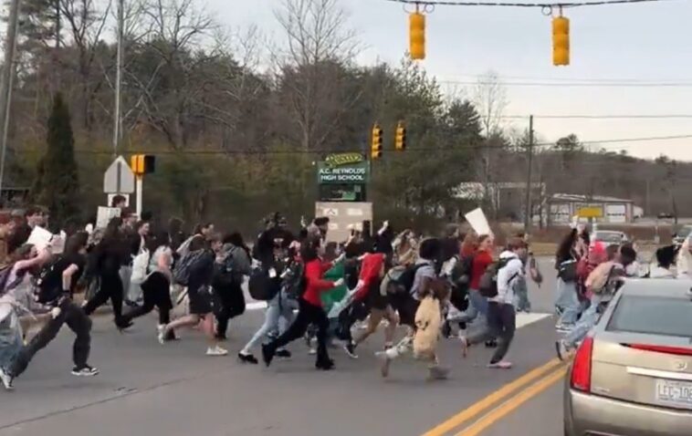 watch:-horrifying-footage-shows-north-carolina-high-school-students-bolt-out-of-class-and-run-across-busy-4-lane-highway-to-protest-ice-–-no-teachers-in-sight